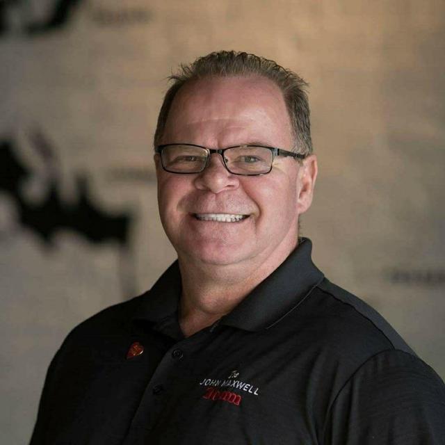 Original photograph: Robert Mitchell, owner of Kwik Dry Restoration & Remodeling, smiling in a black polo shirt